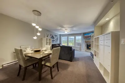 a dining room and living room with a table and chairs at Mountain View Villas with Fairmont Creek Vacation Rentals in Fairmont Hot Springs