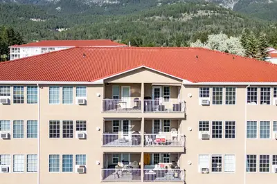 an apartment building with a red roof at Mountain View Villas with Fairmont Creek Vacation Rentals in Fairmont Hot Springs