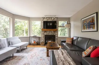 a living room with a couch and a fireplace at Whistler Gleneagle 27 in Whistler
