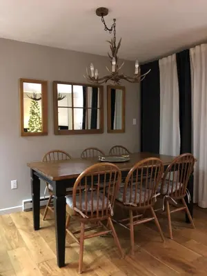 a dining room table with chairs and a chandelier at Whistler Gleneagle 27 in Whistler