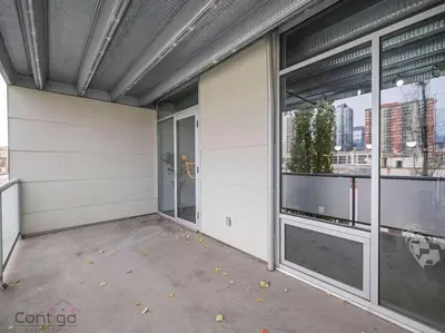 an empty building with large windows in a city at Urban Pop Loft, Near ICE District, UG Parking in Edmonton