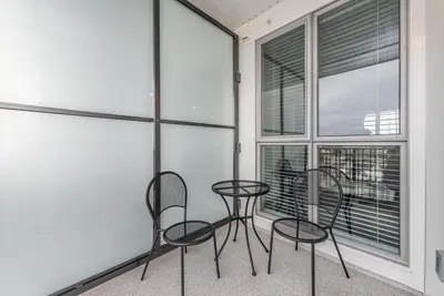 two chairs and a table in a room with windows at Be The Lively Cityzen In Cityzen in Victoria