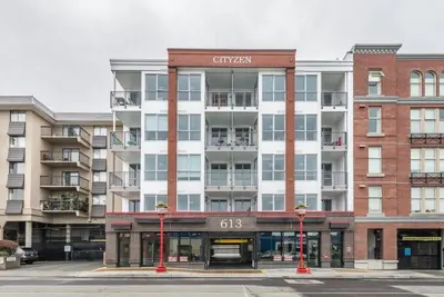 a large apartment building with a sign on it at Be The Civilised Cityzen In Cityzen in Victoria
