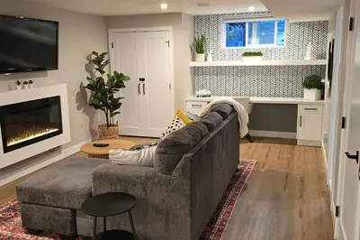 a living room with a couch and a fireplace at Boho Bliss - Just steps away from the Hospital in Prince George