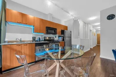 a kitchen with a glass table and some chairs at Lovely 2-Bedrooms Downtown suite Free Parking in Vancouver