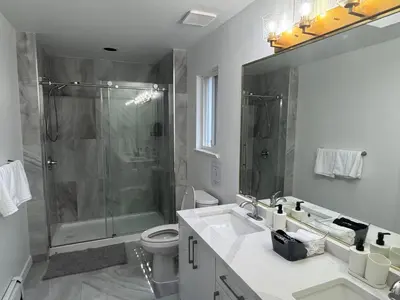 a bathroom with a shower and a toilet and a sink at Spacious Getaway in Surrey in Surrey