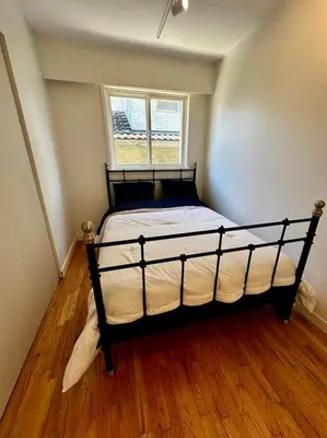 a bedroom with a large bed in a room at Charming East Van Home Near DT and Commercial St in Vancouver