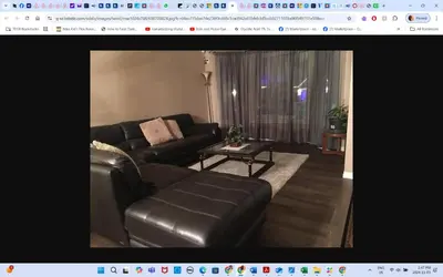 a living room with a leather couch and a table at Master Bedroom private bathroom 23 minutes airport in Edmonton