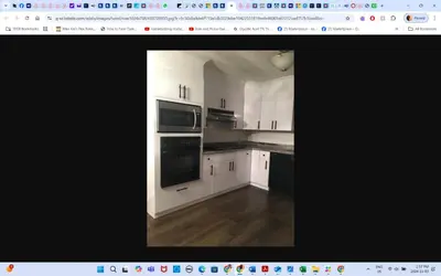 a kitchen with white cabinets and black appliances at Main floor room 4, 22 minute from airport in Edmonton