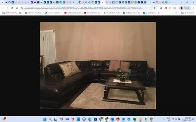 a black leather couch with a coffee table in a living room at Room # 2 sleep 4 Arrangement in Edmonton