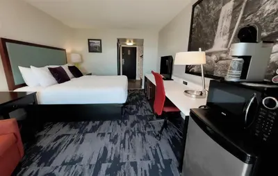 a hotel room with a bed and a desk at The Oceanside, a Coast Hotel in Sechelt