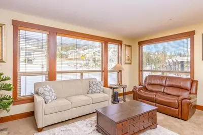 a living room with a couch and a chair at Stonegate Resort Unit A206 in Kelowna