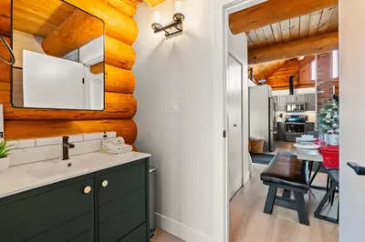 a kitchen with a sink and a counter top at The View Point Lodge Cozy Log House with Hot Tub in Vernon