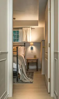 a bedroom with a bed and a table and a window at The Reef guest suite in Sechelt