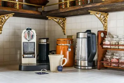 a kitchen counter with a coffee maker and a coffee pot at The Reef guest suite in Sechelt