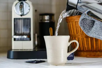 a white coffee cup with water pouring into it at The Reef guest suite in Sechelt