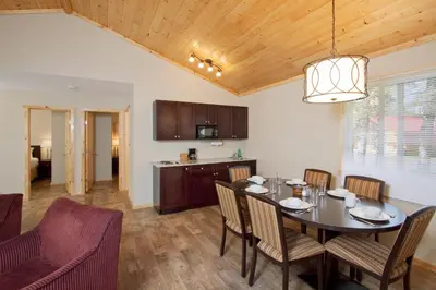 a kitchen and dining room with a table and chairs at Jasper East Cabins in Jasper