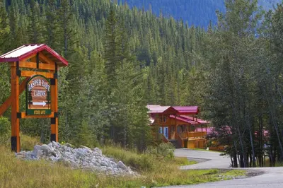 a building with a sign in the middle of a road at Jasper East Cabins in Jasper