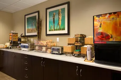 a room with a counter top with a television and appliances at Microtel Inn & Suites by Wyndham Whitecourt in Whitecourt