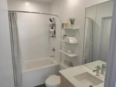 a bathroom with a shower and a toilet and a sink at Modern Cozy Nest in Calgary