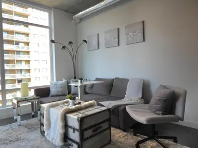 a living room with a couch and a chair at Modern Cozy Nest in Calgary