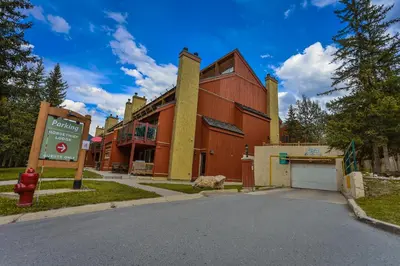 a red building with a fire hydrant in front of it at Horsethief Lodge by StayIn in Panorama