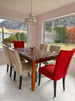 a dining room table with chairs and a red dining room table at Blush Bliss A Peaceful Vineyard Escape in Keremeos