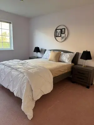 a bedroom with a bed and a mirror on the wall at Blush Bliss A Peaceful Vineyard Escape in Keremeos