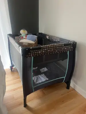 a small black bunk bed in a room at Taurean Vines Guest house in Keremeos