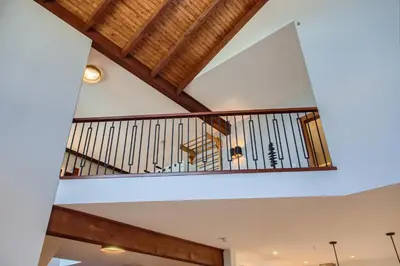 a staircase in a house with wooden ceilings at Moonshine Crescent 365 by Okanagan Premier in Big White
