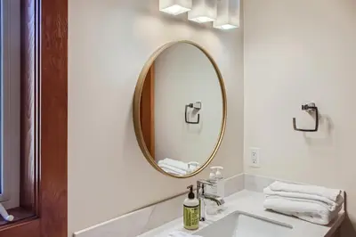 a bathroom with a sink and a mirror at Moonshine Crescent 365 by Okanagan Premier in Big White