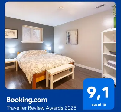 a bedroom with a bed and a book shelf at Hastings Sunrise Experience in Vancouver