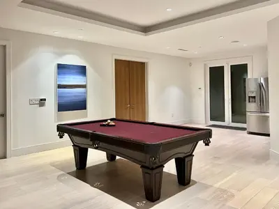 a pool table in a living room with at Two King Bedroom w Bath&Living Room in Vancouver