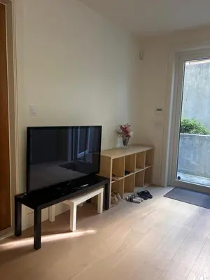 a living room with a large flat screen tv at Two King Bedroom w Bath&Living Room in Vancouver