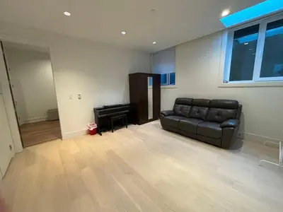 a living room with a couch and a piano at Two King Bedroom w Bath&Living Room in Vancouver