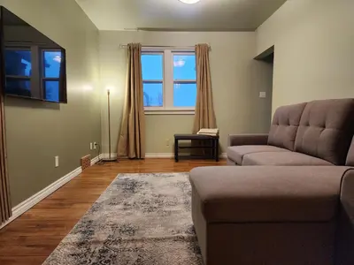 a living room with a couch and a window at 2-bed house for downtown, stampede & mountains in Calgary