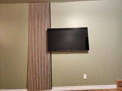 a flat screen tv hanging on a wall at 2-bed house for downtown, stampede & mountains in Calgary