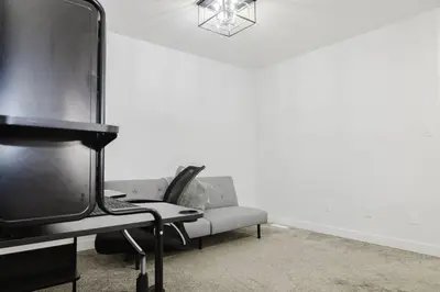 a living room with a couch and a tv at Executive Modern Family Haven for Short Stays in Edmonton