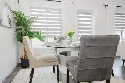 a dining room with a table and two chairs at Executive Modern Family Haven for Short Stays in Edmonton