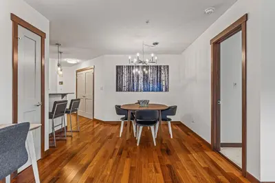 a dining room and kitchen with a table and chairs at Skyline Suite Downtown Canmore Stay in Canmore