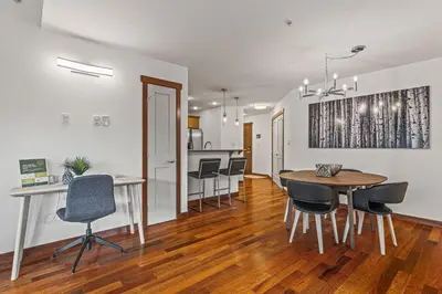 a dining room and kitchen with a table and chairs at Skyline Suite Downtown Canmore Stay in Canmore