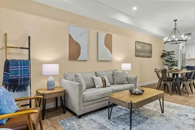a living room with a couch and a table at Stylishly Renovated Spring Creek Retreat in Canmore