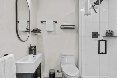 a bathroom with a toilet and a sink and a shower at Scenic Views in a Luxurious Townhouse in Canmore