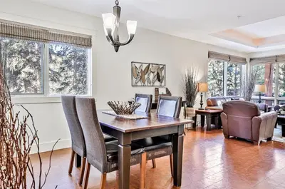 a dining room with a table and chairs at Woodland Retreat 2 Bedroom in Canmore