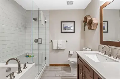 a bathroom with a shower and a sink and a toilet at Alpine Serenity in Canmore in Canmore