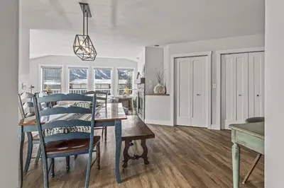 a kitchen and dining room with a table and chairs at Spectacular Rocky Mountain Views 3BD in Canmore