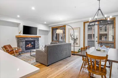 a living room with a couch and a fireplace at Chic Urban Sanctuary in the Heart of Down in Canmore