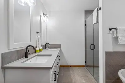 a bathroom with a sink and a shower at Chic Urban Sanctuary in the Heart of Down in Canmore
