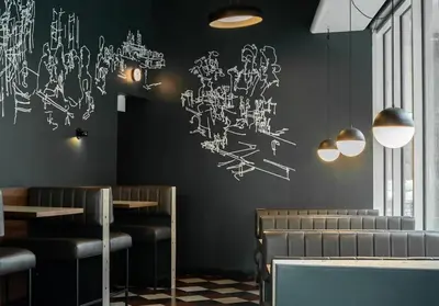 a restaurant with black walls with drawings on the wall at Trendy Glenora , Sleeps 10 , Downtown & River Valley adjacent , Jacuzzi tub! in Edmonton