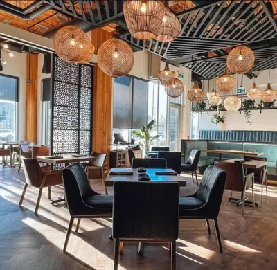 a restaurant with tables and chairs and chandeliers at Trendy Glenora , Sleeps 10 , Downtown & River Valley adjacent , Jacuzzi tub! in Edmonton